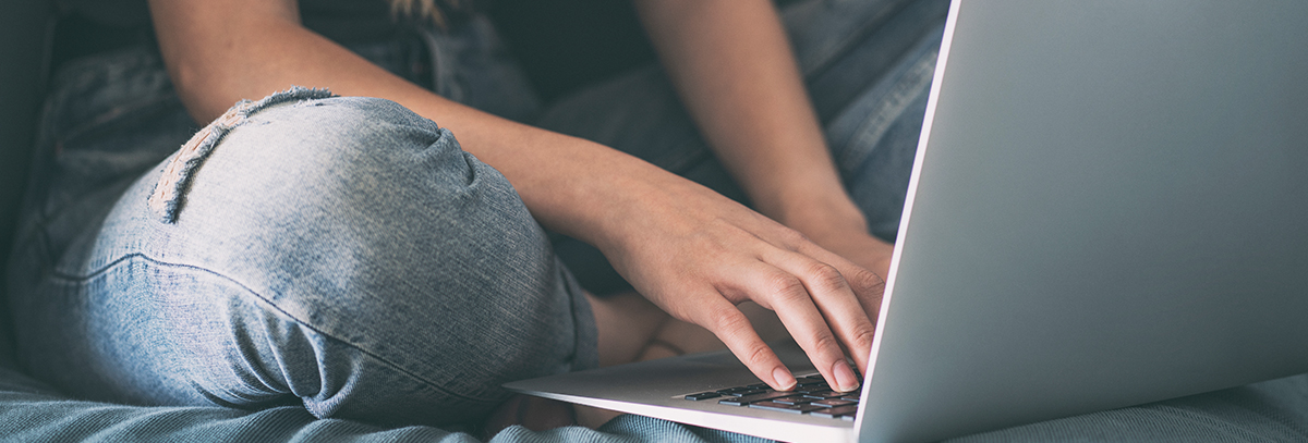 girl typing on laptop