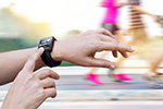 A runner checks heartrate on a wristwatch activity monitor.