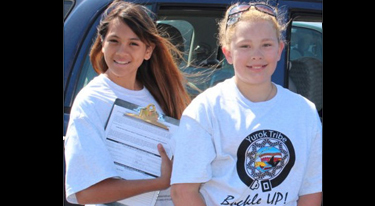 Two girls in t-shirts support motor vehicle injury prevention program among Yurok Tribe in California