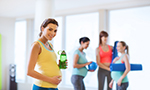 A group of pregnant women participate in low impact aerobic exercise.